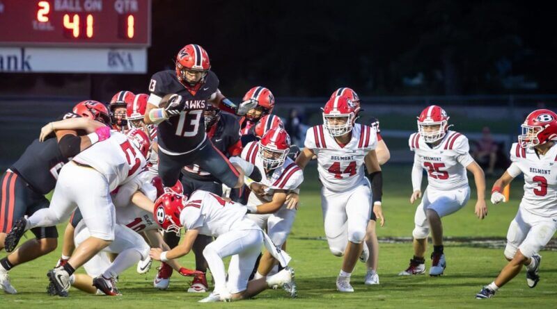 A Myrtle ball carrier (13) breaks through the Belmont defense in the first quarter Friday, Sept. 11, 2026.